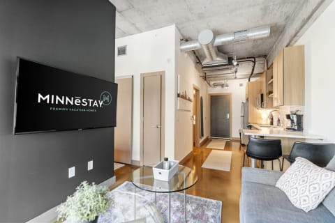 Stylish living area of a vacation home featuring a modern design and MINNēSTAY branding.