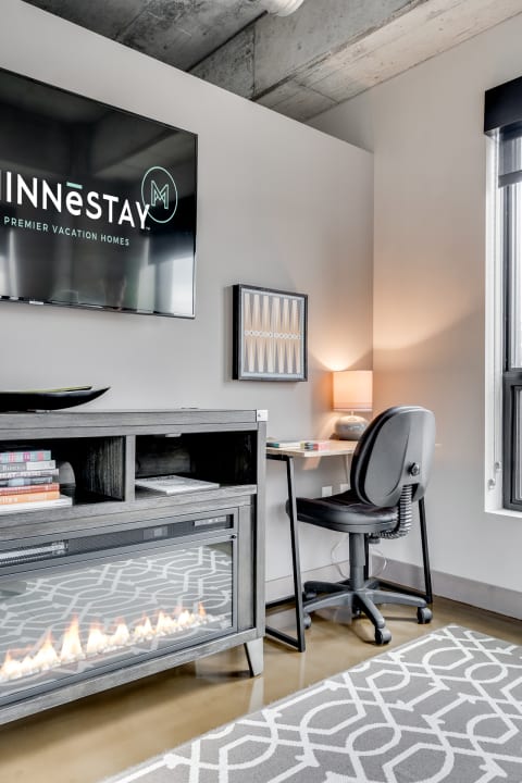 Interior view of a contemporary living space featuring an office area and media unit.