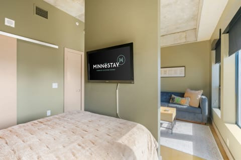 Interior of a modern vacation rental with a bedroom and living area.