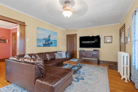 Interior view of a cozy living room featuring a leather sofa and modern amenities.