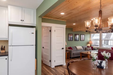 Open-concept living space featuring a kitchen and living room with rustic decor.
